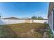 Wide view of the backyard with a shed, offering ample space and enclosed by a clean white fence at 2040 Patriot Way, St Cloud, FL 34769