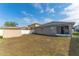 Residential backyard featuring a shed, bordered by a white fence and view of the home's screened lanai at 2040 Patriot Way, St Cloud, FL 34769