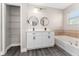 Bathroom featuring double sinks, a soaking tub, and modern finishes at 2040 Patriot Way, St Cloud, FL 34769