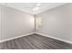 A cozy bedroom with a ceiling fan, neutral walls, and a window providing natural light at 2040 Patriot Way, St Cloud, FL 34769