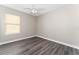 Bright bedroom showcasing a ceiling fan, neutral walls, and new flooring at 2040 Patriot Way, St Cloud, FL 34769