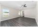 Spacious bedroom featuring new gray flooring and a ceiling fan for added comfort at 2040 Patriot Way, St Cloud, FL 34769