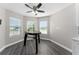 Bright dining area with a modern ceiling fan, complemented by natural light streaming through the windows at 2040 Patriot Way, St Cloud, FL 34769