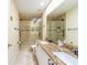 Modern bathroom featuring double sinks with granite countertop and tiled shower at 214 Farrington Ln, Kissimmee, FL 34744