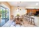 Bright breakfast nook features tile floors and a sliding glass door to the outdoor living space at 214 Farrington Ln, Kissimmee, FL 34744