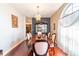 A formal dining room is illuminated by a chandelier and natural light, with hardwood floors and a china cabinet at 214 Farrington Ln, Kissimmee, FL 34744