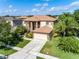 Charming two-story home featuring a well-manicured lawn, complemented by lush landscaping and a two-car garage at 214 Farrington Ln, Kissimmee, FL 34744