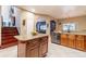 Well-lit kitchen featuring granite countertops, wood cabinets, and stainless steel appliances at 214 Farrington Ln, Kissimmee, FL 34744