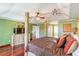 Spacious primary bedroom with a decorative four-poster bed and tray ceilings at 214 Farrington Ln, Kissimmee, FL 34744