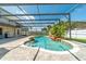 Enclosed pool and patio area with waterfall feature, fountains, and outdoor seating under a screened enclosure at 214 Farrington Ln, Kissimmee, FL 34744