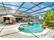 Enclosed pool and patio area with waterfall feature, fountains, and outdoor seating with screened enclosure at 214 Farrington Ln, Kissimmee, FL 34744