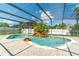 Enclosed pool with waterfall feature, fountains, and paved deck under a screened enclosure at 214 Farrington Ln, Kissimmee, FL 34744