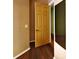 Hallway with a wood floor and a wooden door at 2416 Oak Mill Dr, Kissimmee, FL 34744