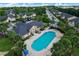 Aerial view of the community pool surrounded by lounge chairs and lush landscaping at 2416 Swailes Dr # 8, Orlando, FL 32837