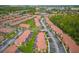 Aerial view of a lush residential neighborhood with townhomes, green spaces, and recreational amenities like lakes at 2634 Corvette Ln, Kissimmee, FL 34746