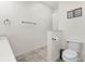 Half bathroom with tile floors, modern toilet and sink, and neutral decor at 2634 Corvette Ln, Kissimmee, FL 34746