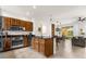Modern kitchen with stainless steel appliances and granite countertops seamlessly flowing into the dining and living areas at 2634 Corvette Ln, Kissimmee, FL 34746