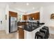 Well-equipped kitchen featuring dark wood cabinetry, granite countertops, and a convenient breakfast bar with seating at 2634 Corvette Ln, Kissimmee, FL 34746