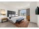 Serene main bedroom with a king-size bed, plush rug, and ample natural light from a large window at 2634 Corvette Ln, Kissimmee, FL 34746