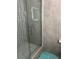 Modern bathroom shower featuring sleek glass door and stylish gray tile at 2638 Eagle Canyon N Dr, Kissimmee, FL 34746