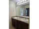 Bathroom featuring a double sink vanity with a large mirror and countertop at 2894 Tanzanite Ter, Kissimmee, FL 34758