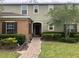 Charming two-story townhome with manicured lawn, walkway, and neat shrubbery around the building at 2894 Tanzanite Ter, Kissimmee, FL 34758