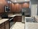 View of the kitchen with stainless steel appliances and a tiled backsplash at 2894 Tanzanite Ter, Kissimmee, FL 34758