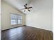 Bright bedroom with a vaulted ceiling, a ceiling fan, hardwood floors, and a window overlooking a view at 2993 Kokomo Loop, Haines City, FL 33844