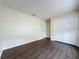 A cozy bedroom featuring hardwood floors, a closet, and neutral walls at 2993 Kokomo Loop, Haines City, FL 33844