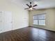 Bedroom featuring hardwood floors, a ceiling fan, and a large window at 2993 Kokomo Loop, Haines City, FL 33844