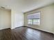 Bedroom with wood-look floors, large window, and closet at 2993 Kokomo Loop, Haines City, FL 33844