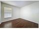 Bedroom with modern wood-look floors and a large window at 2993 Kokomo Loop, Haines City, FL 33844