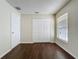 Bedroom with wood-look floors, large window and a closet at 2993 Kokomo Loop, Haines City, FL 33844