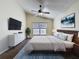 Bedroom showcasing hardwood floors, a bed, and a ceiling fan beneath a vaulted ceiling at 2993 Kokomo Loop, Haines City, FL 33844