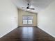 Bright bedroom with a vaulted ceiling, a ceiling fan, and hardwood floors at 2993 Kokomo Loop, Haines City, FL 33844