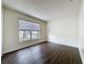 Bedroom with wood-look floors and a window with neighborhood views at 2993 Kokomo Loop, Haines City, FL 33844