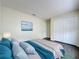 Bright bedroom featuring a large closet, wood-look floors, and a calming blue color scheme at 2993 Kokomo Loop, Haines City, FL 33844