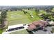 Aerial view of a clubhouse, driving range, and golf course, showcasing community amenities at 2993 Kokomo Loop, Haines City, FL 33844