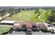 Aerial view of a clubhouse, driving range and putting green at 2993 Kokomo Loop, Haines City, FL 33844