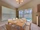 Dining area with a modern table setting and sliding door views of the outdoor pool at 2993 Kokomo Loop, Haines City, FL 33844