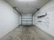 Spacious garage with painted walls, concrete floor, and overhead door at 2993 Kokomo Loop, Haines City, FL 33844