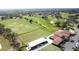 Aerial view of a driving range and golf course showing a manicured fairway and lush landscaping at 2993 Kokomo Loop, Haines City, FL 33844