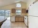 Bright kitchen with tile floors, neutral cabinets, appliances and a slider to the outside at 2993 Kokomo Loop, Haines City, FL 33844