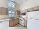 Bright kitchen with modern appliances, a window, and ample cabinetry for storage at 2993 Kokomo Loop, Haines City, FL 33844