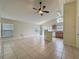 Open-concept living space showcasing tiled floors, vaulted ceilings, and a breakfast bar at 2993 Kokomo Loop, Haines City, FL 33844