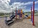 Colorful playground featuring slides, stairs, monkey bars, and safety mulch at 2993 Kokomo Loop, Haines City, FL 33844