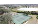 Aerial image of the tennis courts near a picturesque pond and playground, promising recreation and relaxation at 2993 Kokomo Loop, Haines City, FL 33844