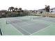 Aerial shot of the tennis courts shows well-maintained grounds and lush surroundings at 2993 Kokomo Loop, Haines City, FL 33844