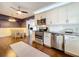 Open kitchen and dining area features stainless steel appliances, granite countertops and hardwood floors at 3004 Lake Margaret Dr, Orlando, FL 32806