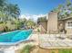 A beautiful backyard oasis with a sparkling swimming pool and lush tropical landscaping at 3004 Lake Margaret Dr, Orlando, FL 32806